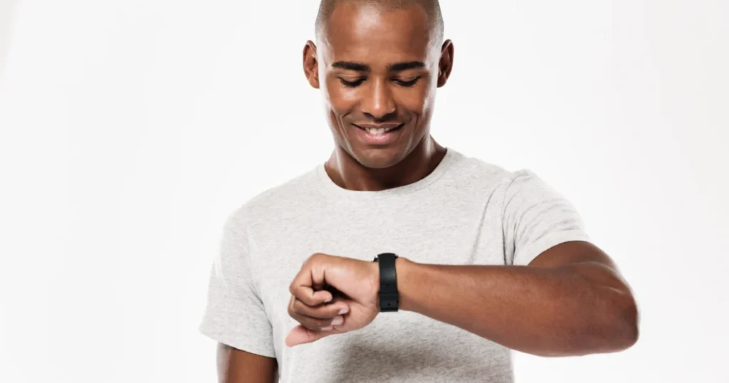 Young man checking his watch while waiting for a loan application decision