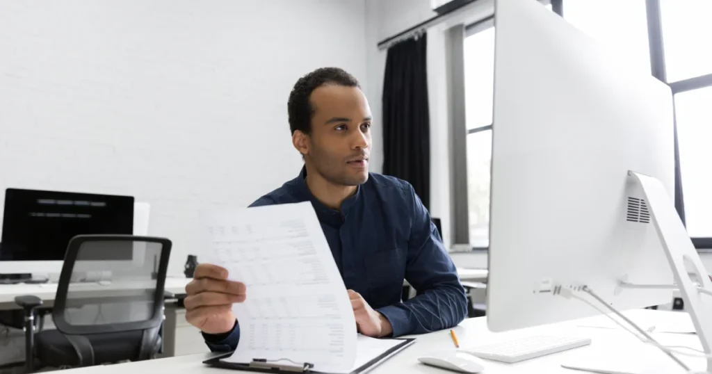 Employee at his desk reviewing the terms of a loan that does not require collateral