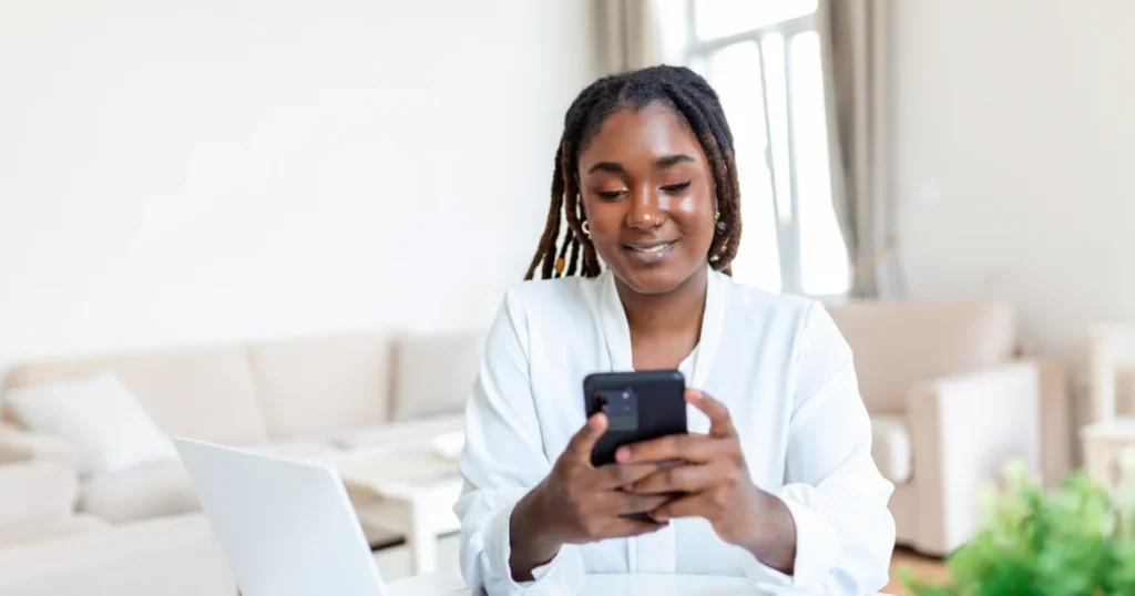 Young woman using a smartphone to complete a secure online loan application